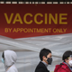People stand in line to receive a covid-19 vaccine at a vaccination site at Lincoln Park on January 28, 2021 in Los Angeles, California.